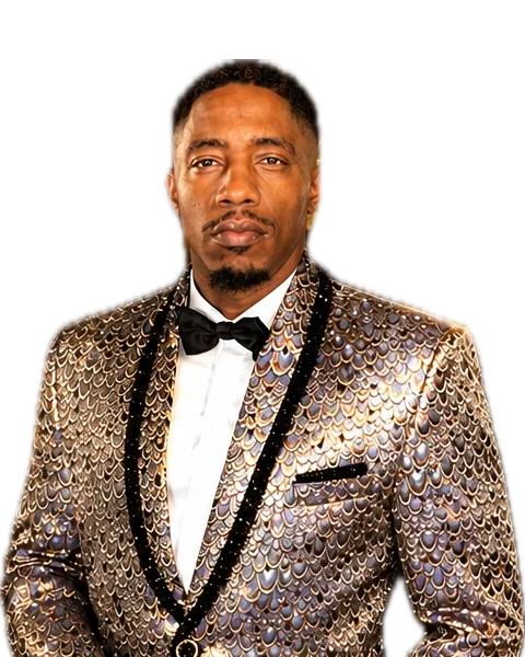 Portrait of Buda Infiniti Ross in a gold sequined tuxedo jacket and black bow tie, looking straight ahead.